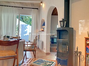 Enjoy meals in the dining area with a stove and comfortable seating.