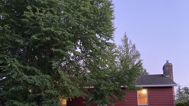 A two-story house with a red exterior, a chimney, and a porch with outdoor seating. - Relax on the Ranch…..HOT TUB, SHEEP (Sultan)