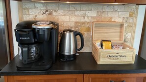 A kitchen counter with a Keurig coffee maker, a Hamilton Beach coffee pot, and a wooden box labeled "The General Store". - Relax on the Ranch…..HOT TUB, SHEEP (Sultan)