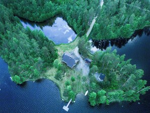 An aerial view of a secluded property with a house, a dock, and a small boat. - Suvituuli by Interhome (Pertunmaa)