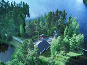 A lakeside cabin with a dock, surrounded by dense forest and a small pond. - Suvituuli by Interhome (Pertunmaa)
