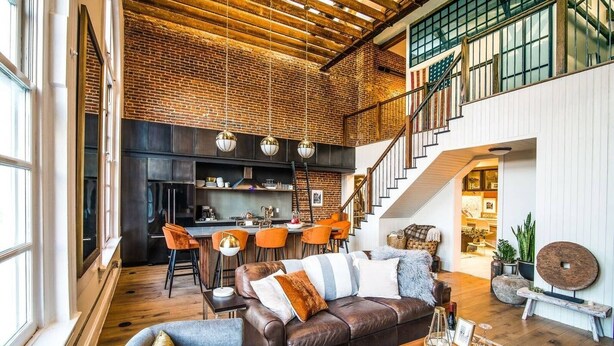 A spacious loft with a kitchen, dining area, and living room. - Historic DC Firehouse Penthouse Loft (Washington)