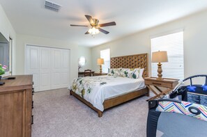 A bedroom with a wooden bed, a ceiling fan, a nightstand, a lamp, a chair, and a window with blinds. - 6 Bedroom 5 Bathroom 9045hs (Davenport)