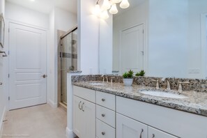 A bathroom with two sinks, a large mirror, and a shower area. - Golden Bear Villa Reunion (Kissimmee)
