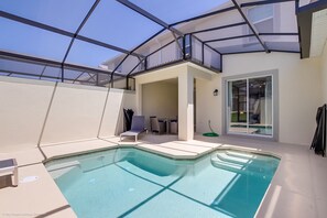 A modern indoor pool area with a glass ceiling, a pool table, and a seating area. - Stinger Drive Villa Champions Gate 2 (Davenport)