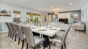 A modern dining area with a marble table, leather chairs, and a decorative centerpiece. - 6121bod 11 Bedroom 9 Bathroom (Davenport)