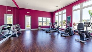 A gym with treadmills, elliptical machines, and weight machines. - Lucaya Village Resort 4 Bedroom Townhome 2901 (Lake Buena Vista)