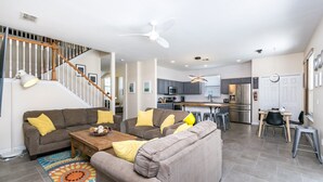 A spacious living room with a staircase, a kitchen, and a dining area. - Luxury 5 Bedroom 4 Bath Villa With Bespoke 468bel (Davenport)