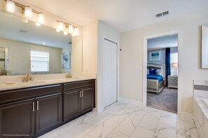 A bathroom with a large mirror, dark cabinets, and a white tiled floor. - Amazing 6 Bedroom 6 Bathroom Fiji Model 9034sd (Davenport)