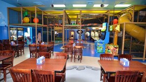 A children's play area with climbing structures, slides, and arcade games. - Clabria Villa Regal Palms (Davenport)