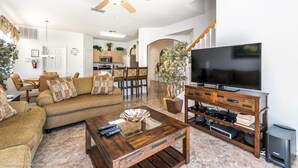 A spacious living room with a large flat-screen TV, wooden coffee table, and comfortable seating. - 215glen Amazing Newly Decorated 5 Bedroom (Davenport)