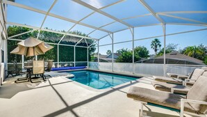 A covered swimming pool area with lounge chairs and a table, surrounded by a white canopy. - 215glen Amazing Newly Decorated 5 Bedroom (Davenport)