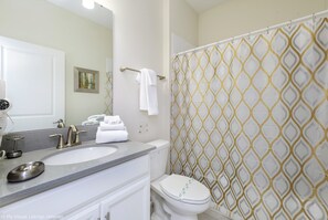 A bathroom with a sink, mirror, and toilet. - Flange Drive Champions Gate 1564 (Davenport)