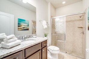A bathroom with a glass-enclosed shower, a sink with a granite countertop, and a toilet. - 1939majorca Fantastic 5 Bed 4 Bathroom Town Home (Kissimmee)