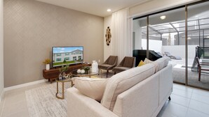 A modern living room with a sofa, armchairs, a coffee table, and a flat-screen TV. - Sydney Villa Windsor At Westside 1 (Kissimmee)
