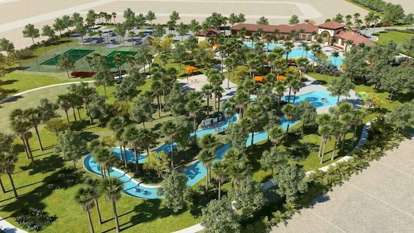 Vista aérea de un complejo turístico con varias piscinas, palmeras y villas para huéspedes.