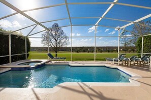 A covered swimming pool with lounge chairs and a view of a green landscape. - Gleneagles Drive Highalnds Reserve 3 (Davenport)