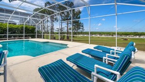 A pool area with lounge chairs and a covered section. - Belfry Drive Villa Highlands Reserve 4 (Davenport)