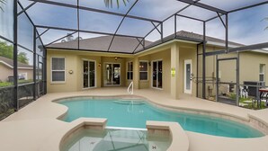 A swimming pool with a glass enclosure, a hot tub, and a covered patio area. - 4 Bed Villa 732bd (Davenport)