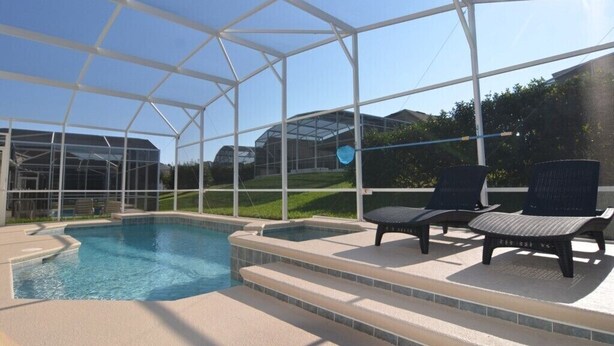 A covered outdoor swimming pool with steps leading down to the water, surrounded by a white metal frame. - Bonville Drive Villa Highlands Reserve (Davenport)