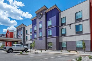 A multi-story hotel with a modern design, featuring a prominent Sleep Inn sign.