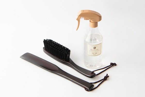A spray bottle, a black hairbrush, and a black comb.