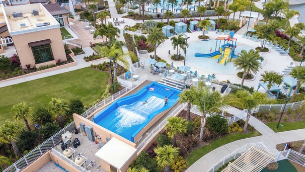 An aerial view of a resort with a large swimming pool, lounge areas, and a water park. - Family Friendly 4Bd with Pool Solara Resort 1517 (Kissimmee)