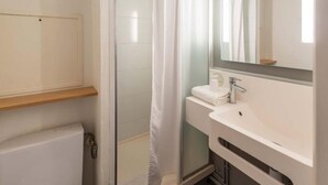 Une salle de bain avec une douche, des toilettes et un lavabo.