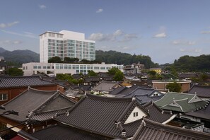A traditional Japanese town with a modern building in the background. - Lahan Hotel Jeonju (Jeonju)