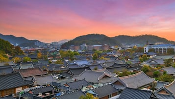 A traditional village with numerous buildings featuring dark tiled roofs and wooden structures.
