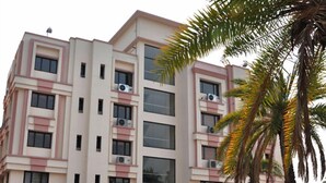 A multi-story building with a modern architectural design, featuring balconies and air conditioning units. - LBD Resorts & Hotels (Kolkata)
