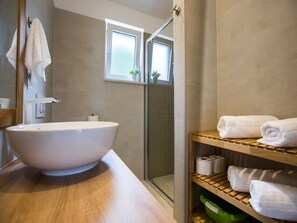 Sink, shower, and towels are conveniently located in this bathroom.