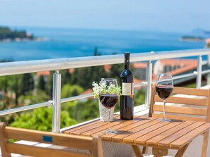 Enjoy a romantic dinner on the balcony with a stunning coastal view.