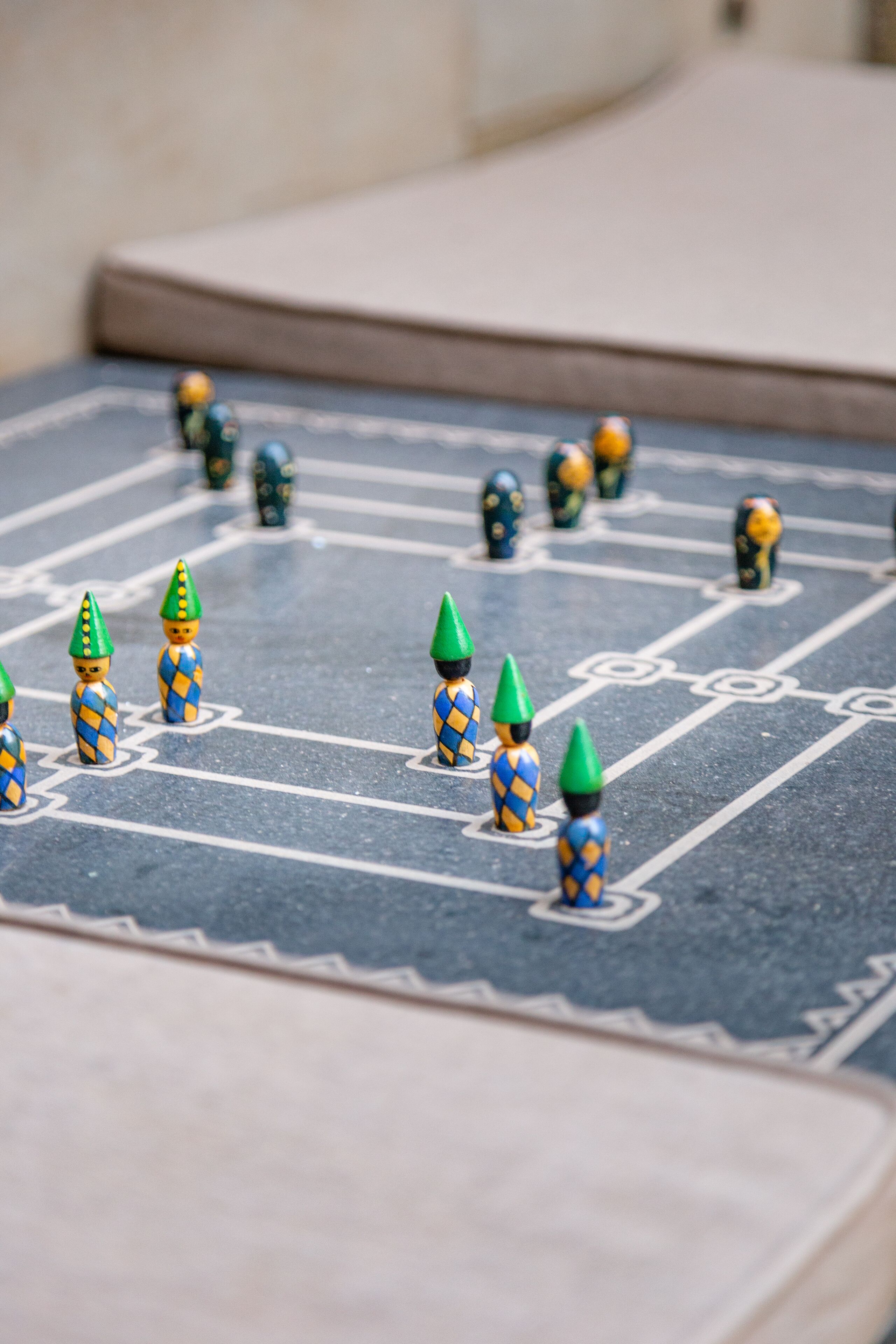 A board game with checkered pattern and game pieces on a flat surface.