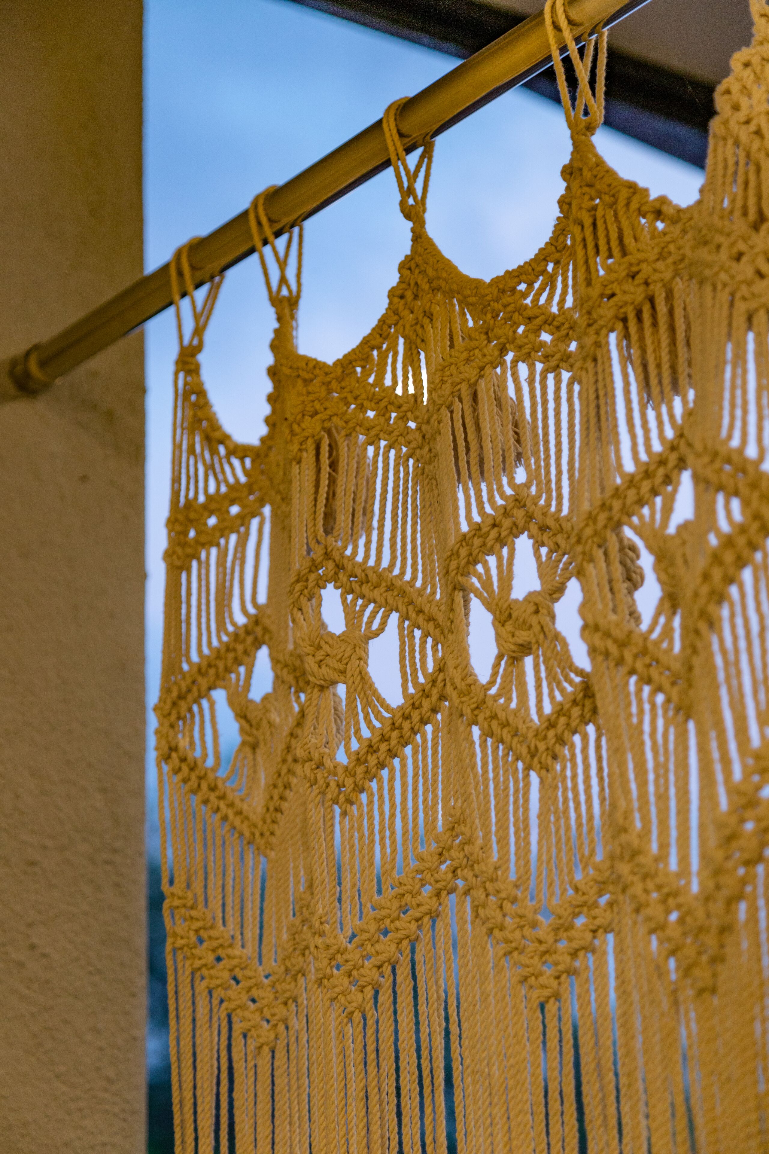 A macramé wall hanging with a complex knot pattern.