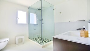 A modern bathroom with a glass-enclosed shower, a white toilet, a small white bench, and a wooden vanity with a white sink. - CENTRAL and Renovated. PANORAMIC SEA VIEWS. Garden (Sainte-Maxime)