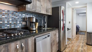 A modern kitchen with a built-in stove, coffee maker, and dishwasher. - 3 Bedroom Balcony, 3 Hot Tubs, AC (Medellin)