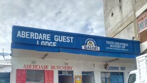 A building with signs for 'Aberdare Guest Lodge' and 'Aberdare Butchery'. - Aberdare Guest House (Naivasha)