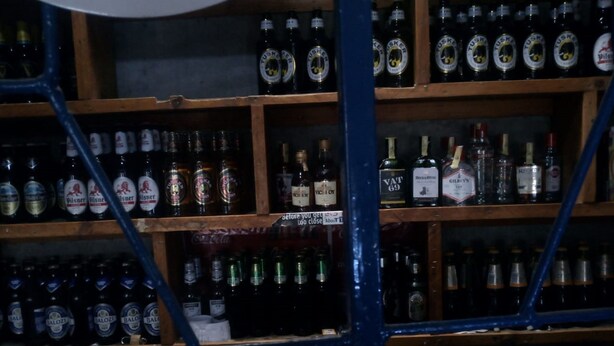 A bar with shelves stocked with various bottles of alcohol, including brands like Pilsner and Balooz. - Aberdare Guest House (Naivasha)