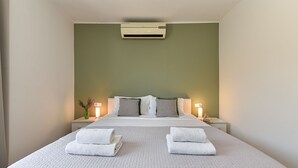 A neatly made bed with white linens and two folded towels, a bedside lamp, and a wall-mounted air conditioner. - Villa 2019/28699 (Istria - Poreč), 3000m from the beach (Poreč)