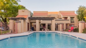 A swimming pool with a pergola, lounge chairs, and a covered patio area. - Cozy condo near MCC, pool, covered parking (Mesa)