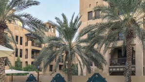 Outdoor pool - Gorgeous 1BR in Souk al Manzil - Sleeps 4 (Dubai)