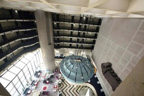 A multi-level interior with a central atrium, multiple floors, and a circular seating area. - Hotel Holiday (Sarajevo)