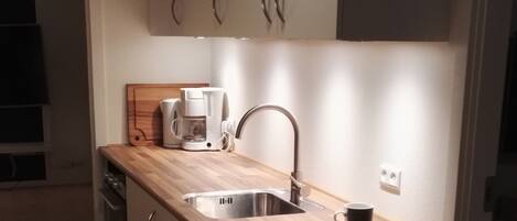 Driepersoonskamer (private kitchen - not in room) | Privékeuken | Een minikoelkast, een microgolfoven, een oven, een kookplaat