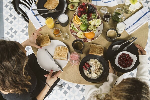 A breakfast setting with toast, fruit, and beverages on a table. - The Hey Hotel (Interlaken)