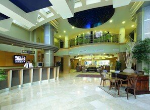 A hotel lobby with a reception desk, seating area, and a starry ceiling. - Grand Cettia (Marmaris)