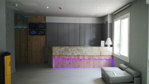 A modern kitchen with a marble countertop, wooden paneling, and a built-in bench. - Sun Beach (Lloret de Mar)