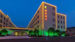 A hotel with a modern design, featuring a prominent entrance and multiple floors. - Linzhen Hotel (Shanghai)