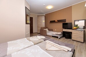 A hotel room with two beds, a desk, a chair, a television, and a wardrobe. - Complex Villa Brigantina (Nessebar)