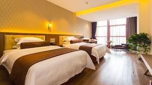 A hotel room with two beds, a desk, and a large window. - James Joyce Coffetel (Zhengzhou)